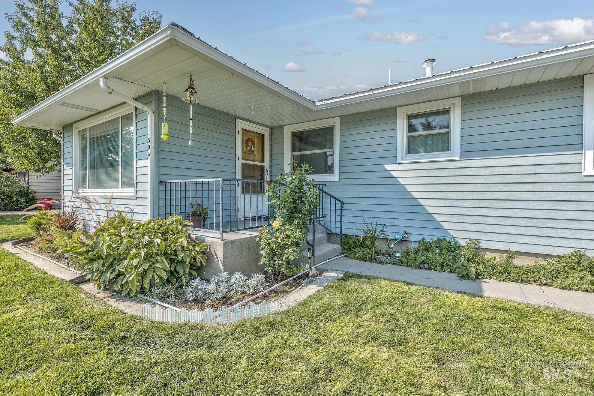 Doorway to property with a lawn