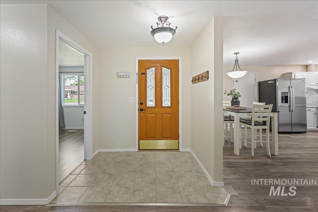 Entryway with baseboards and light wood-type flooring