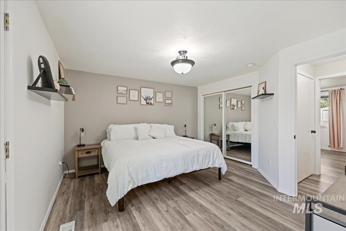 Bedroom featuring wood finished floors and a closet