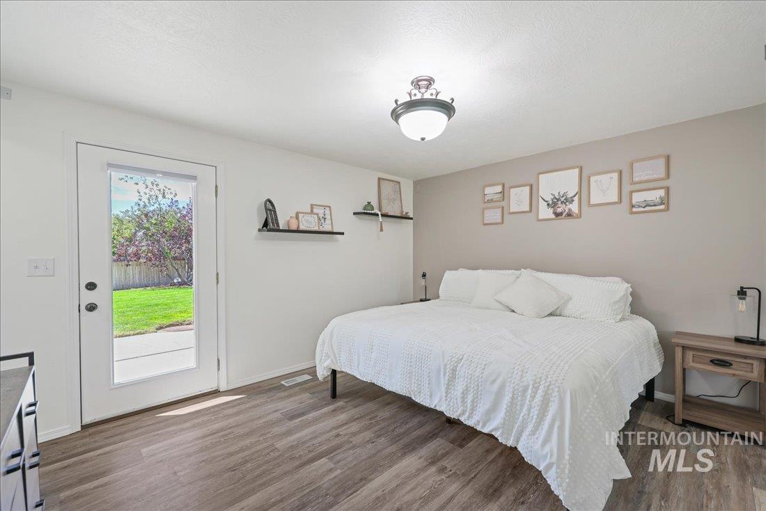 Bedroom with access to outside and wood finished floors