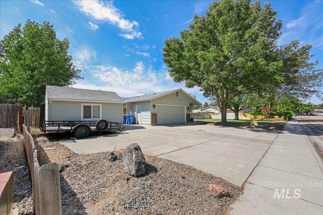 Single story home with driveway, a garage, and a shingled roof