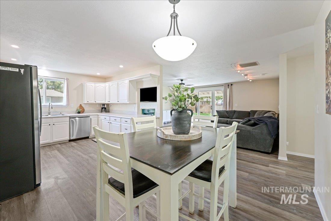 Dining area featuring light wood finished floors, plenty of natural light, and recessed lighting