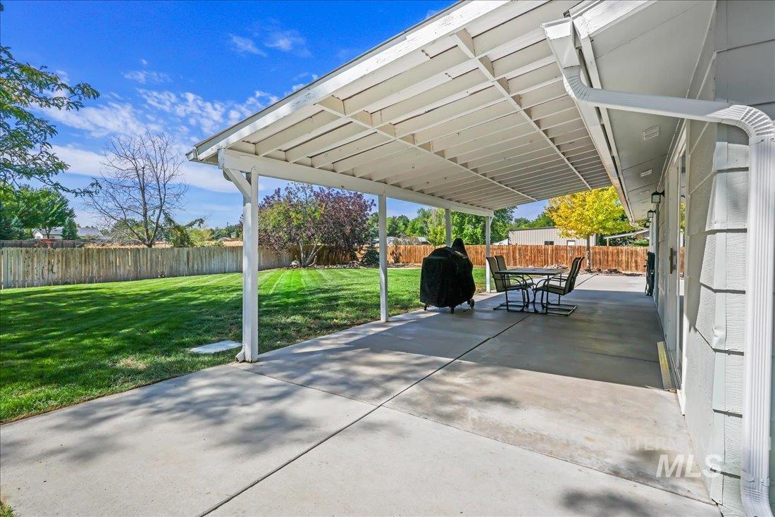 Fenced backyard with a patio and grilling area