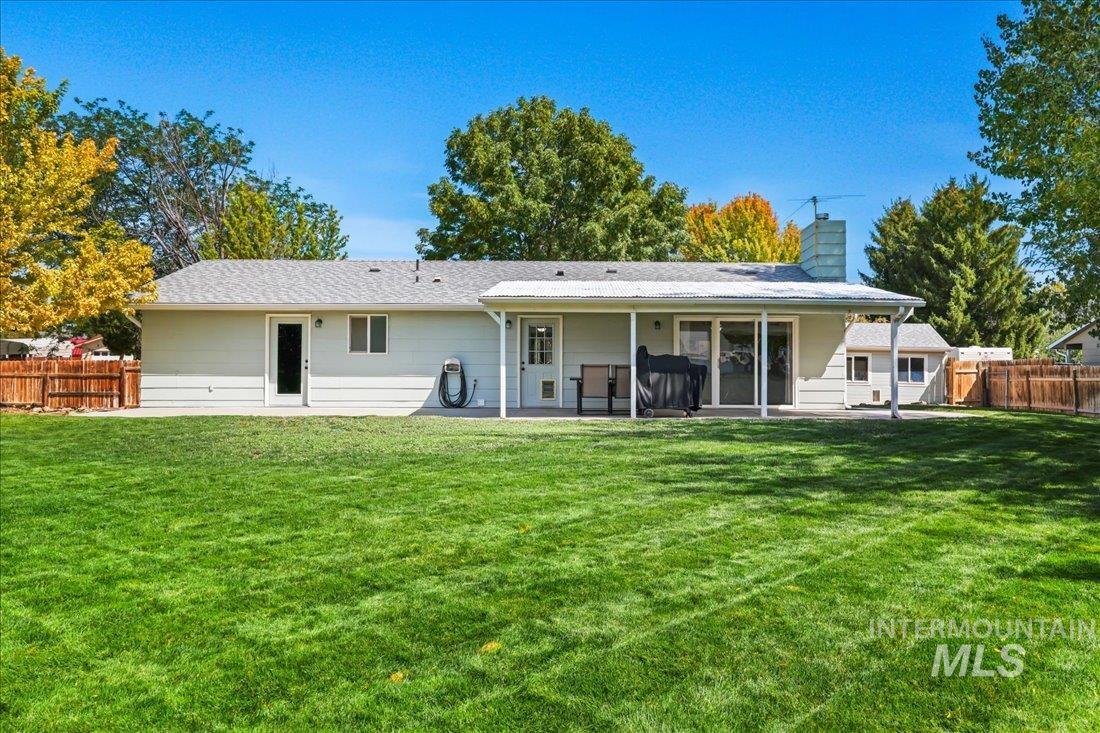 Rear view of property featuring a patio area and a chimney
