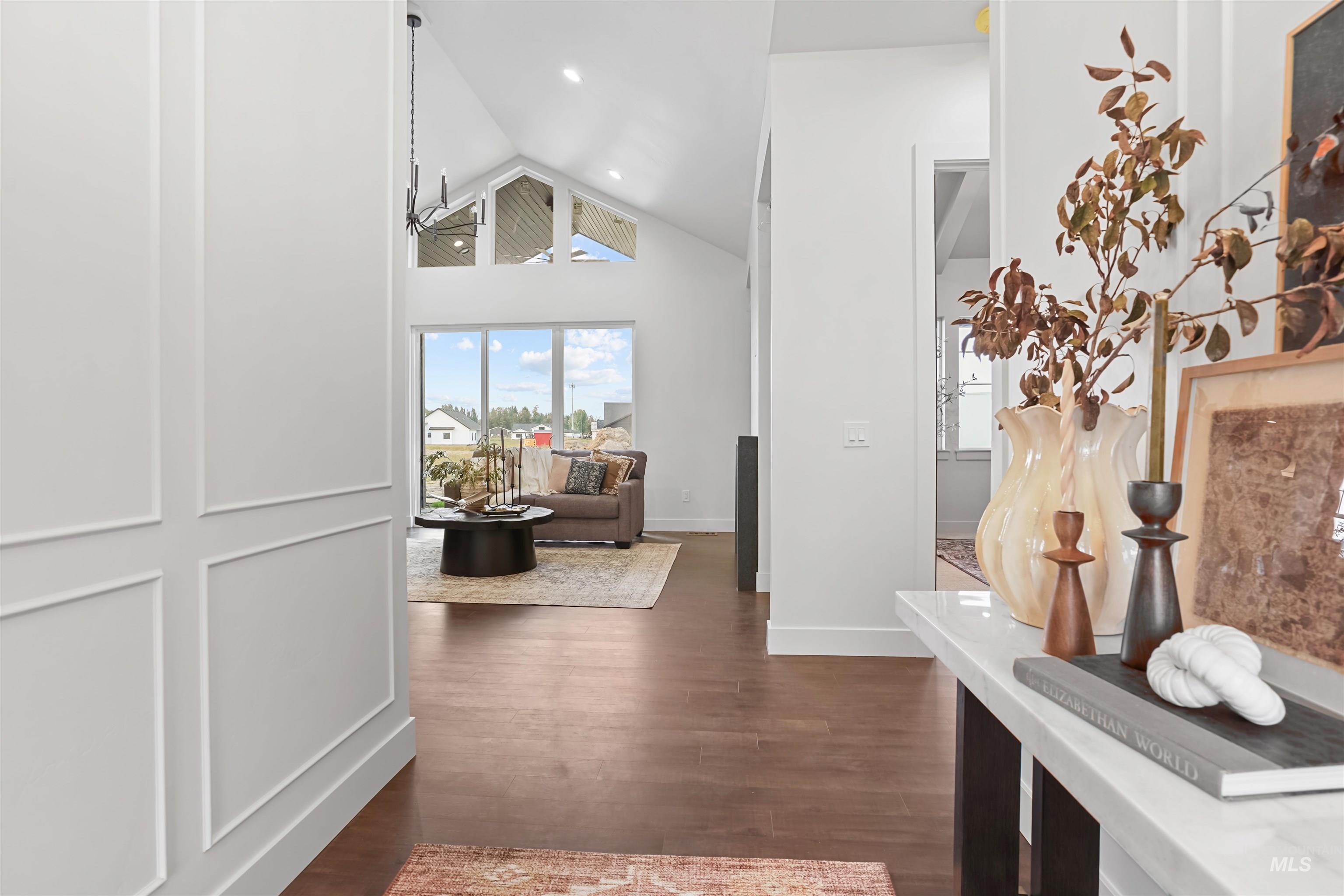 Corridor with high vaulted ceiling and dark wood finished floors