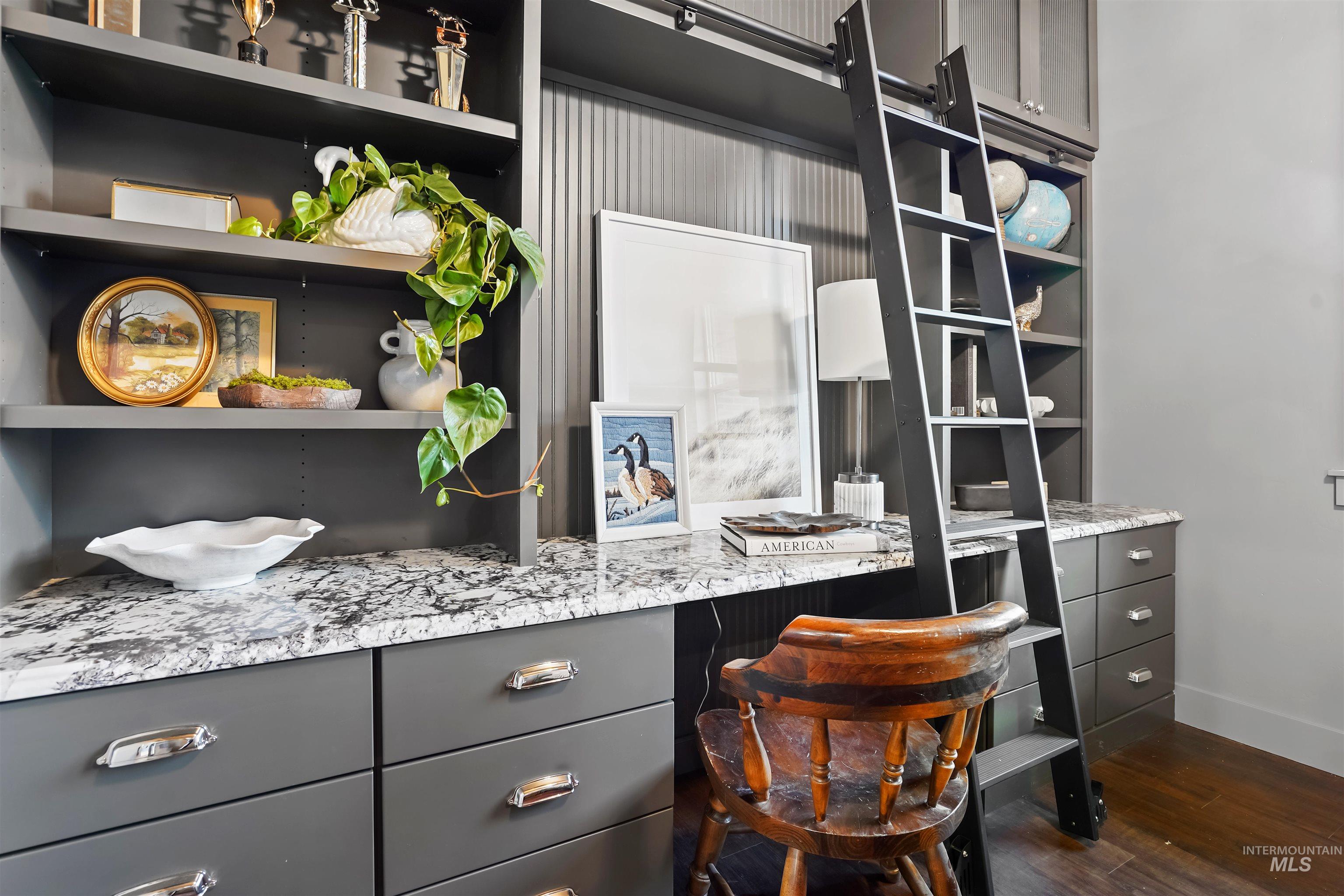 Office area featuring dark wood-style floors and baseboards