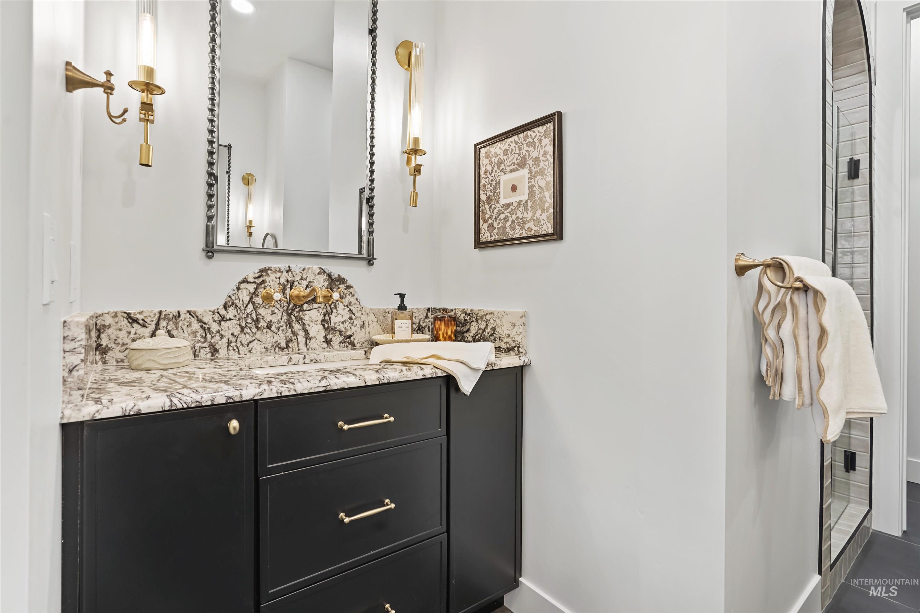 Bathroom with vanity and dark tile patterned flooring