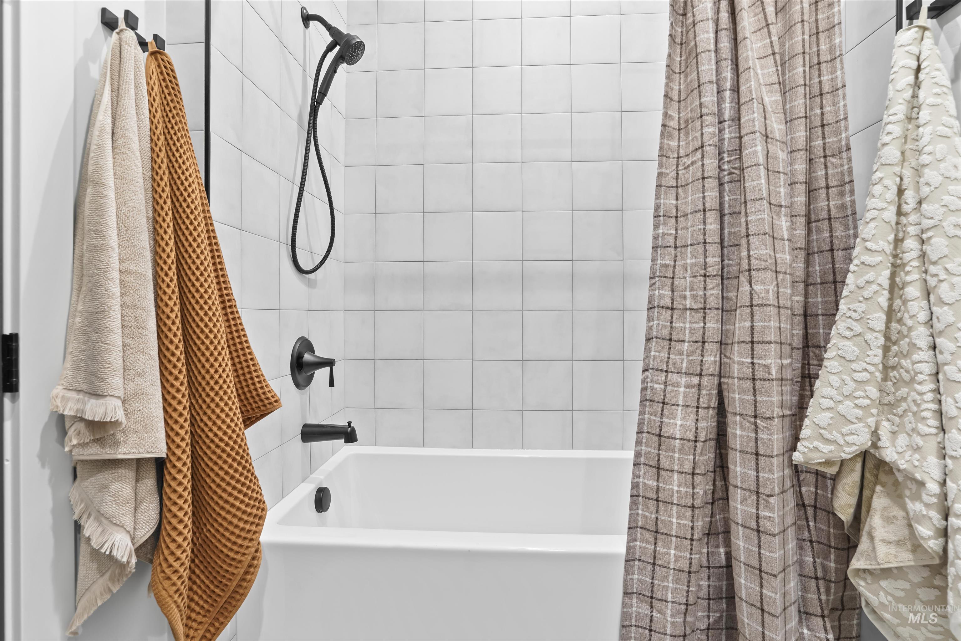 Bathroom featuring shower / bath combination with curtain