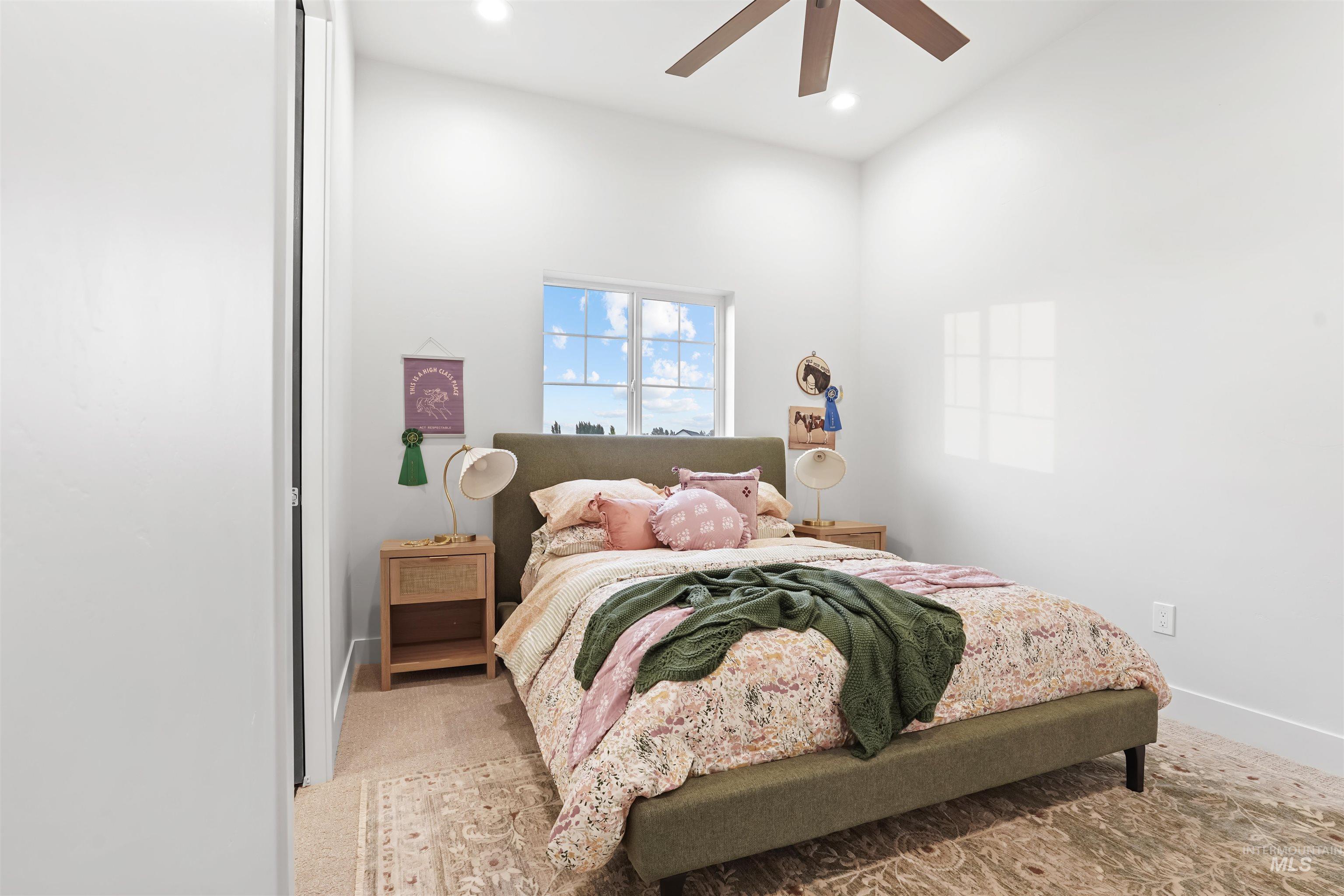 Bedroom with light colored carpet, a ceiling fan, and recessed lighting