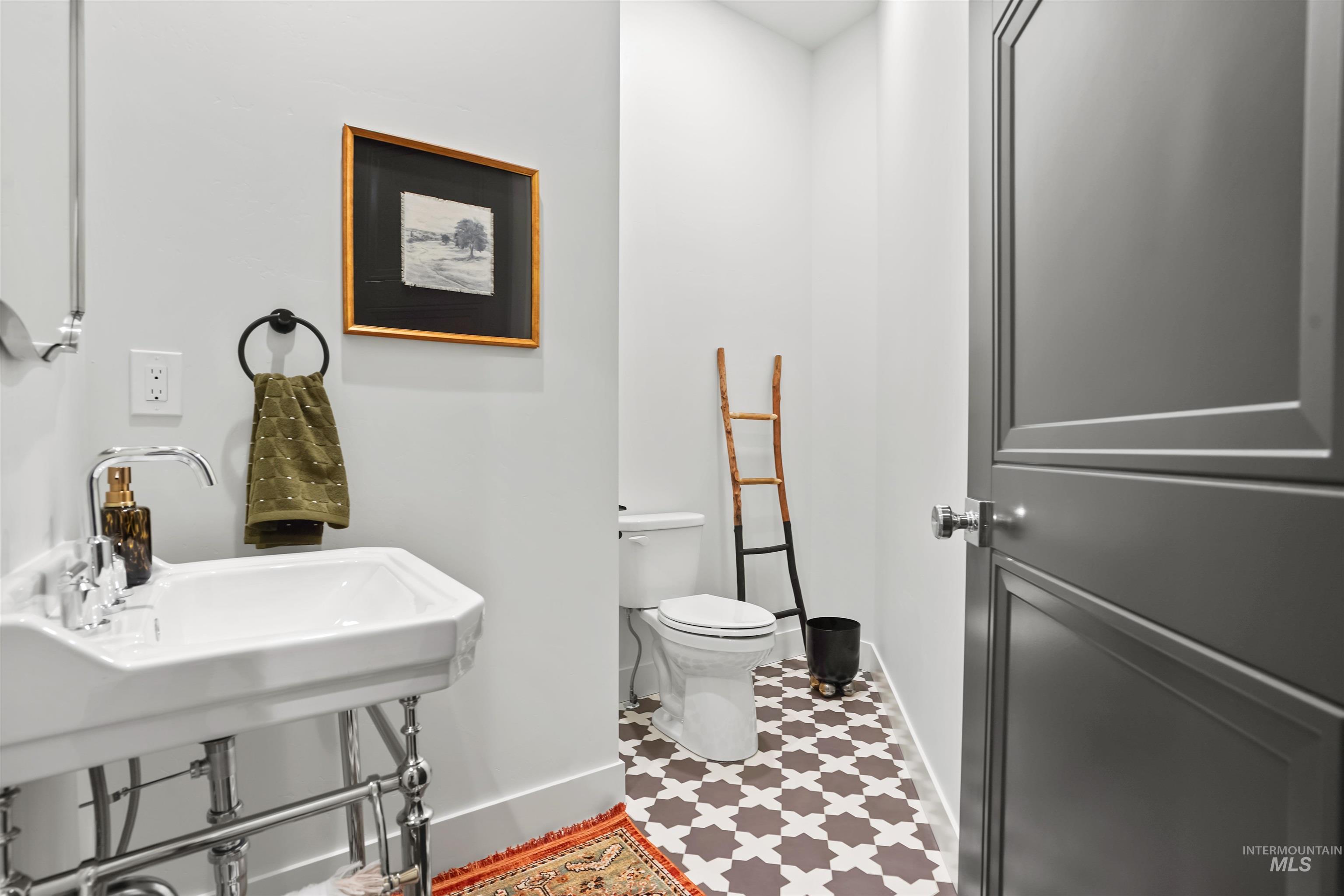 Bathroom with toilet and baseboards