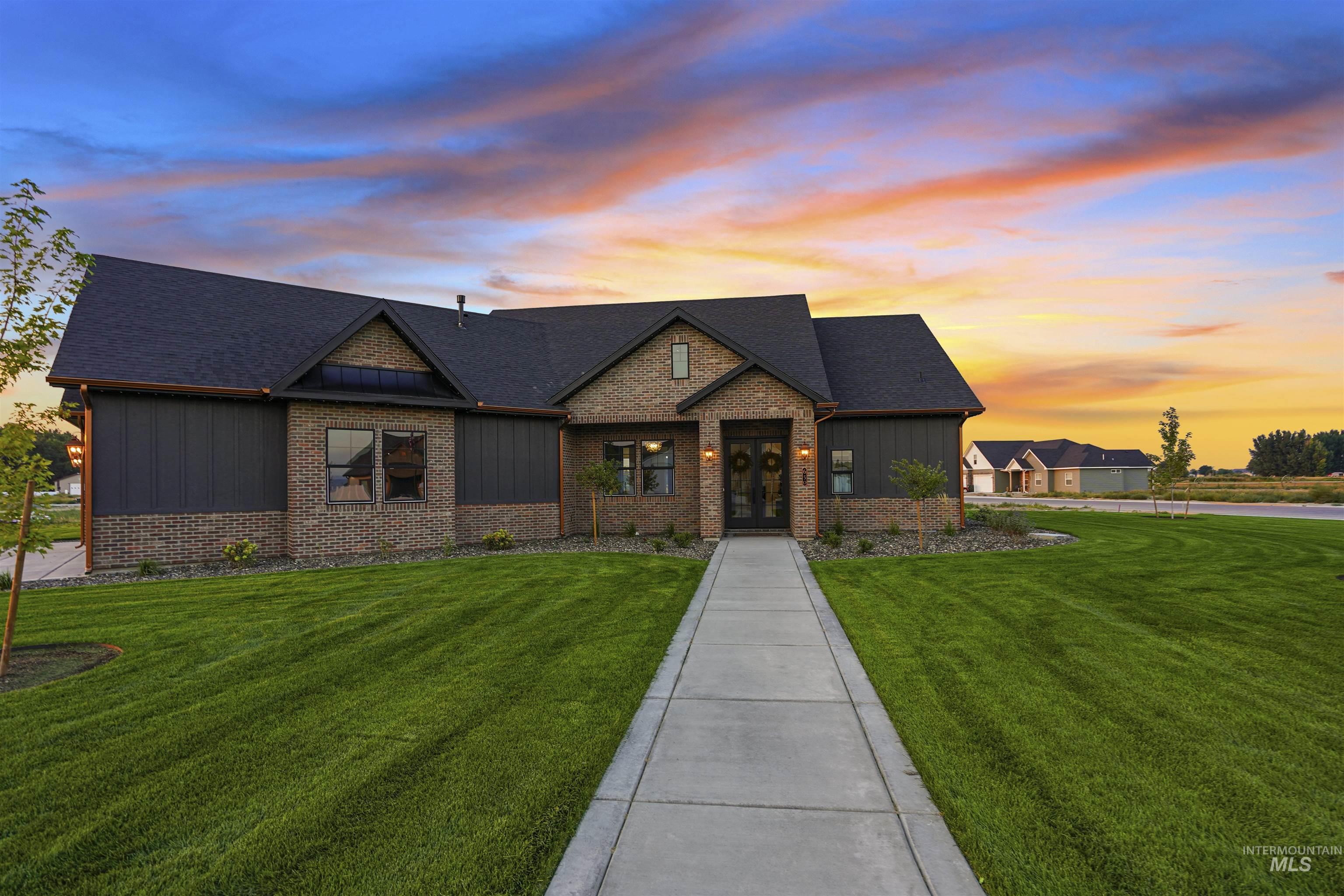 Craftsman-style home featuring a lawn, board and batten siding, and a shingled roof