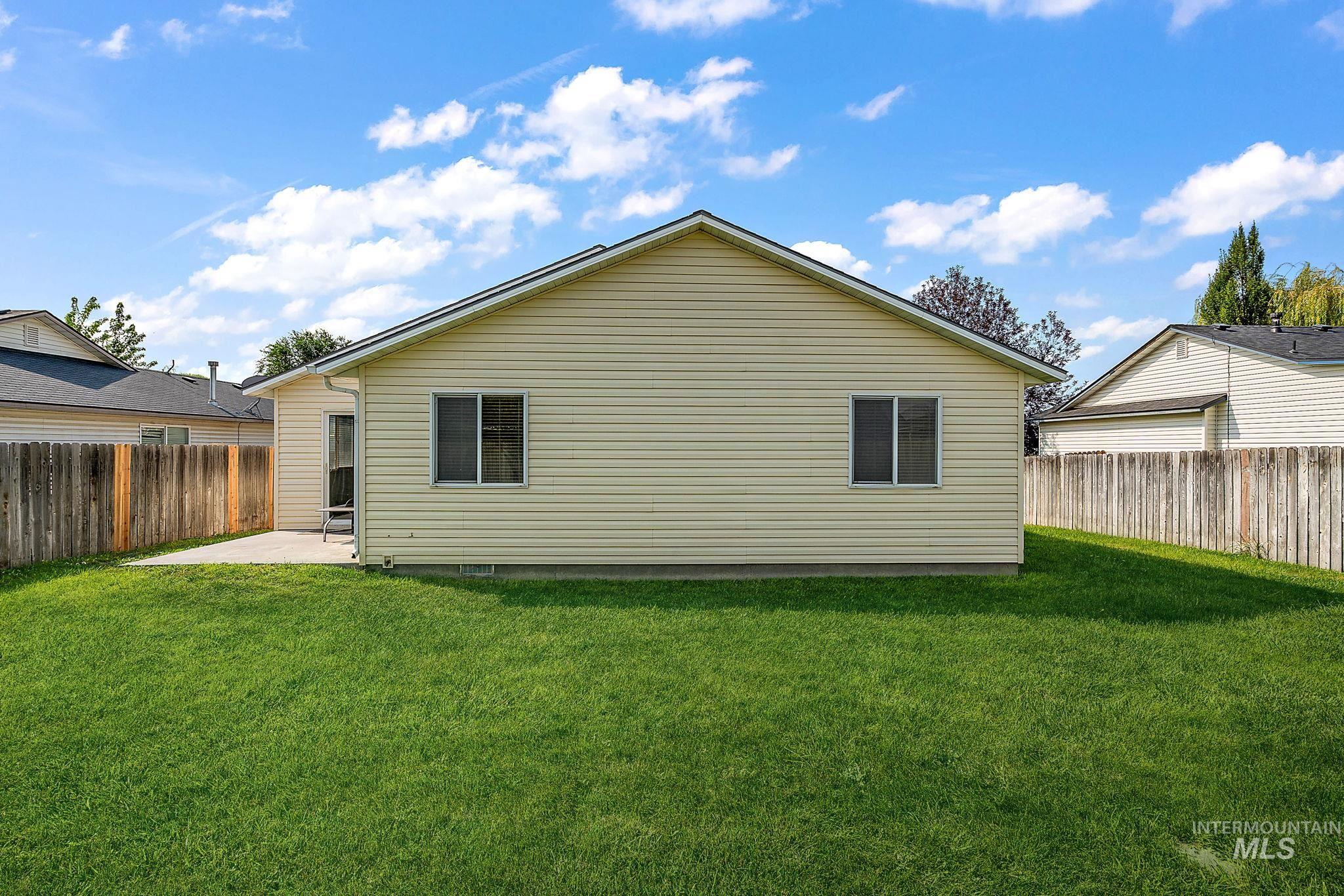 Back of property with a patio area and a fenced backyard