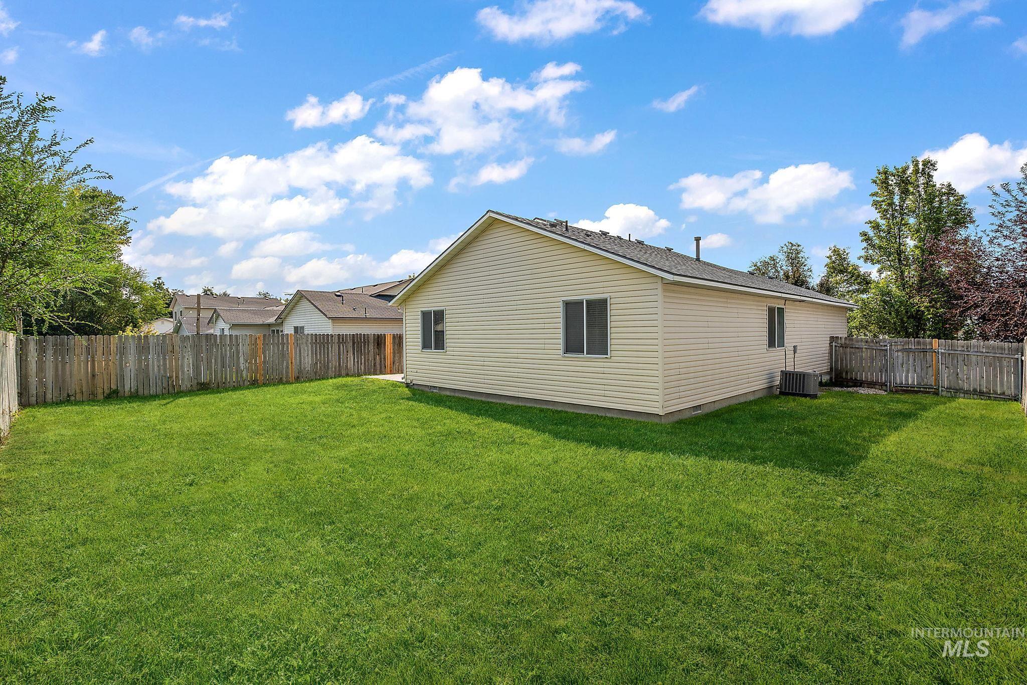 Back of property with a fenced backyard