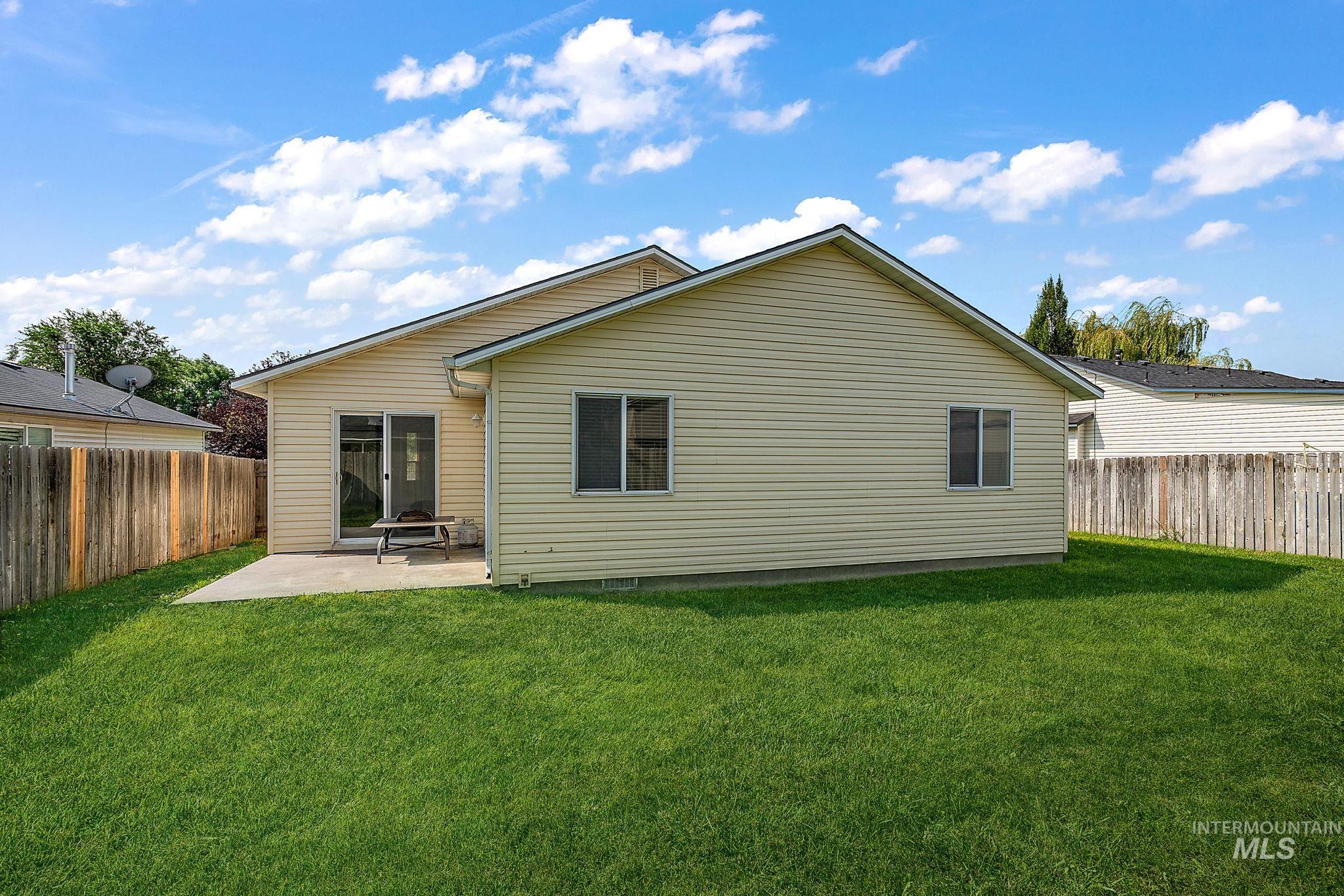 Back of property featuring a fenced backyard and a patio area
