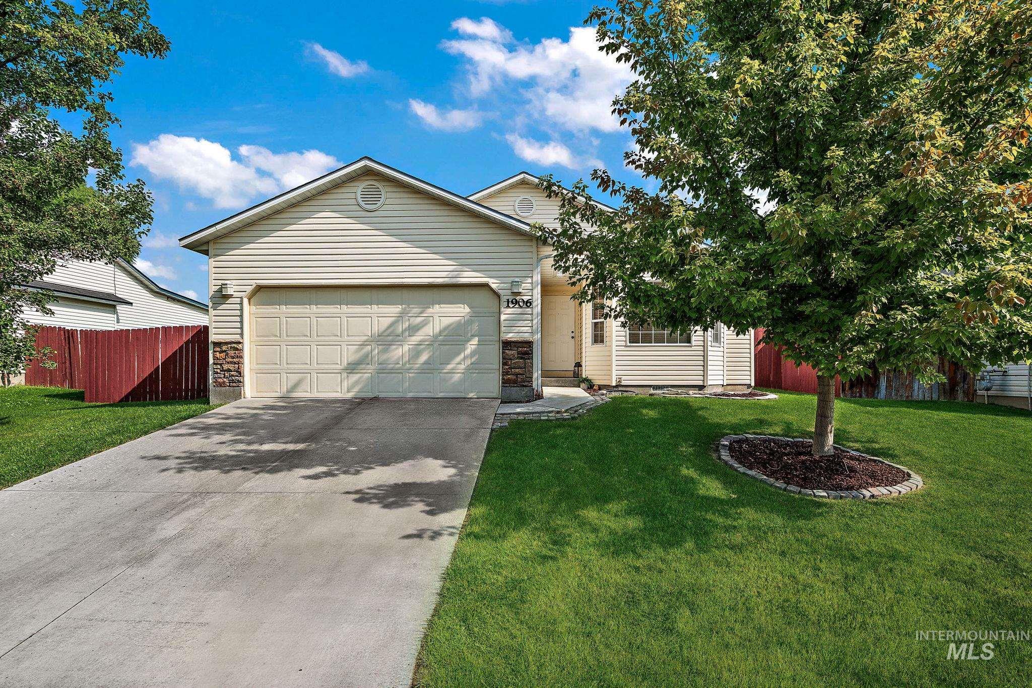 Ranch-style home featuring concrete driveway and a garage