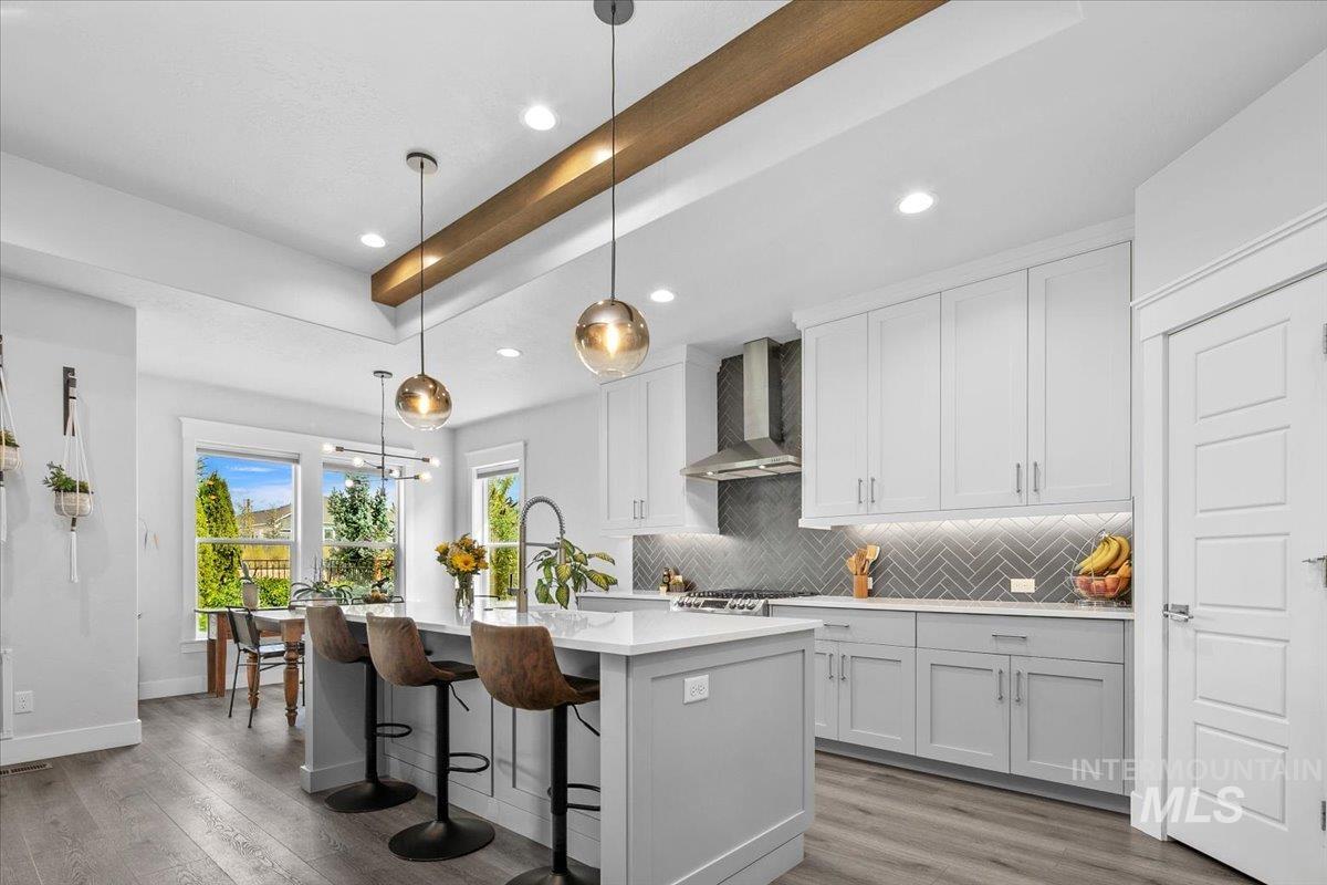 Kitchen featuring pendant lighting, backsplash, dark wood finished floors, and recessed lighting