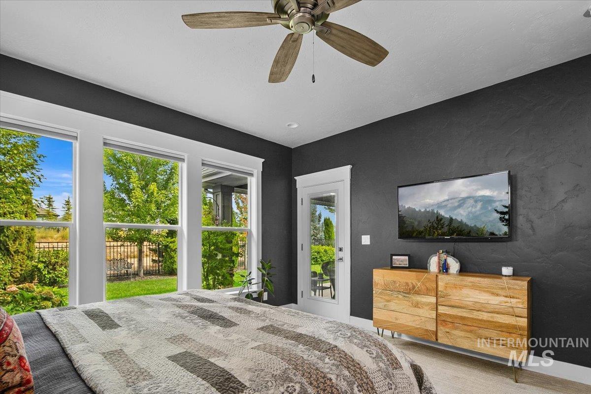 Bedroom featuring access to exterior, a ceiling fan, and carpet floors