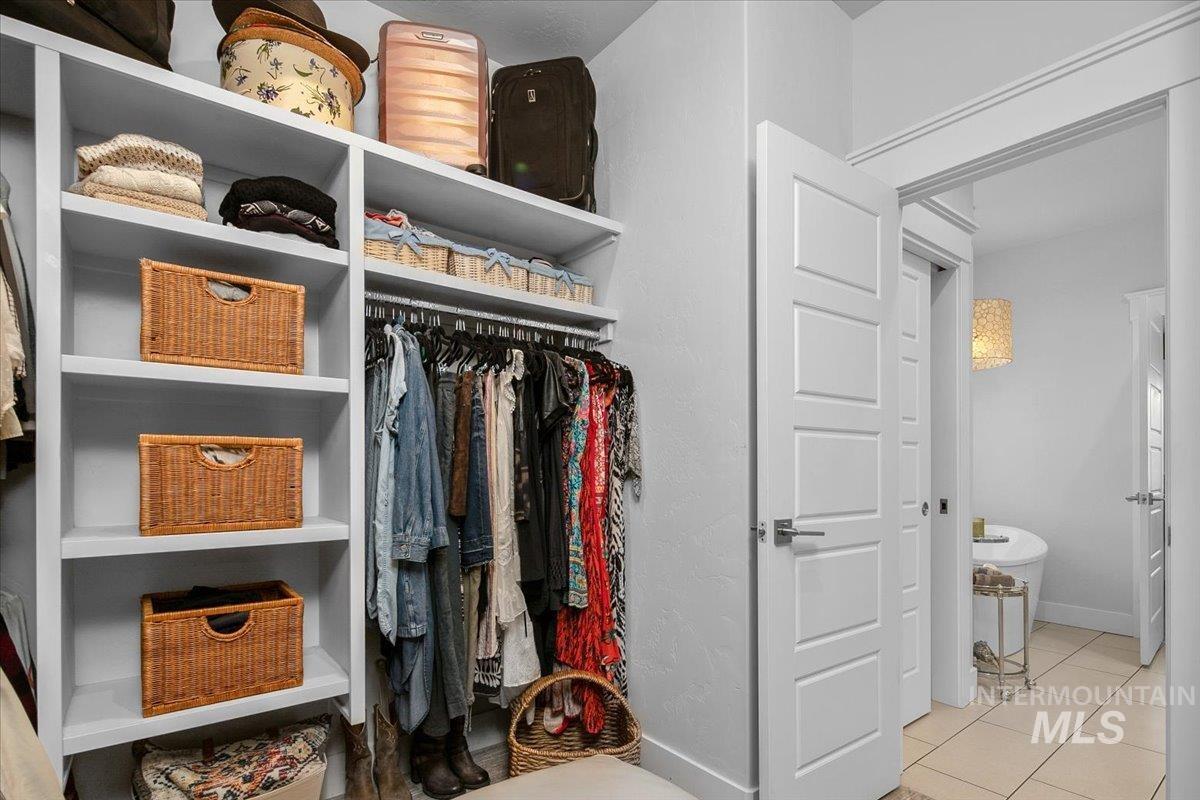 Spacious closet featuring light tile patterned floors