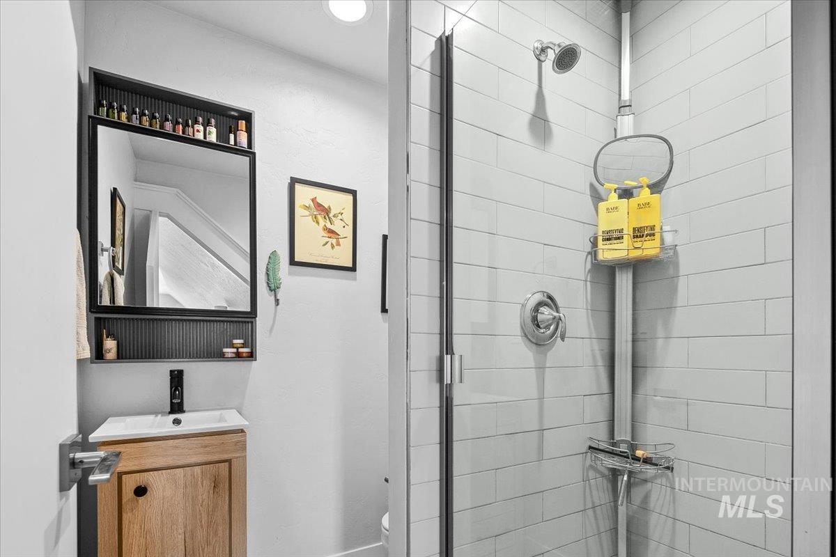 Full bathroom with a stall shower and vanity