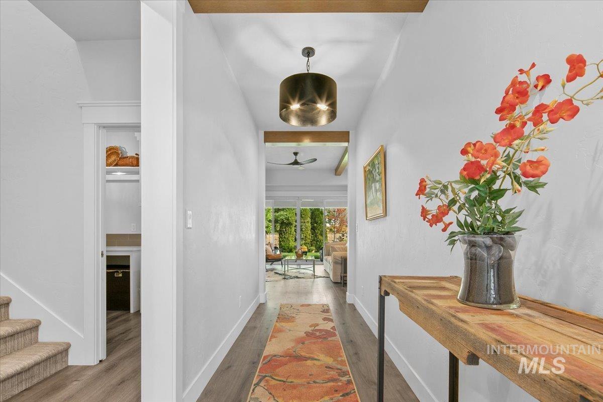 Hall featuring wood finished floors and baseboards
