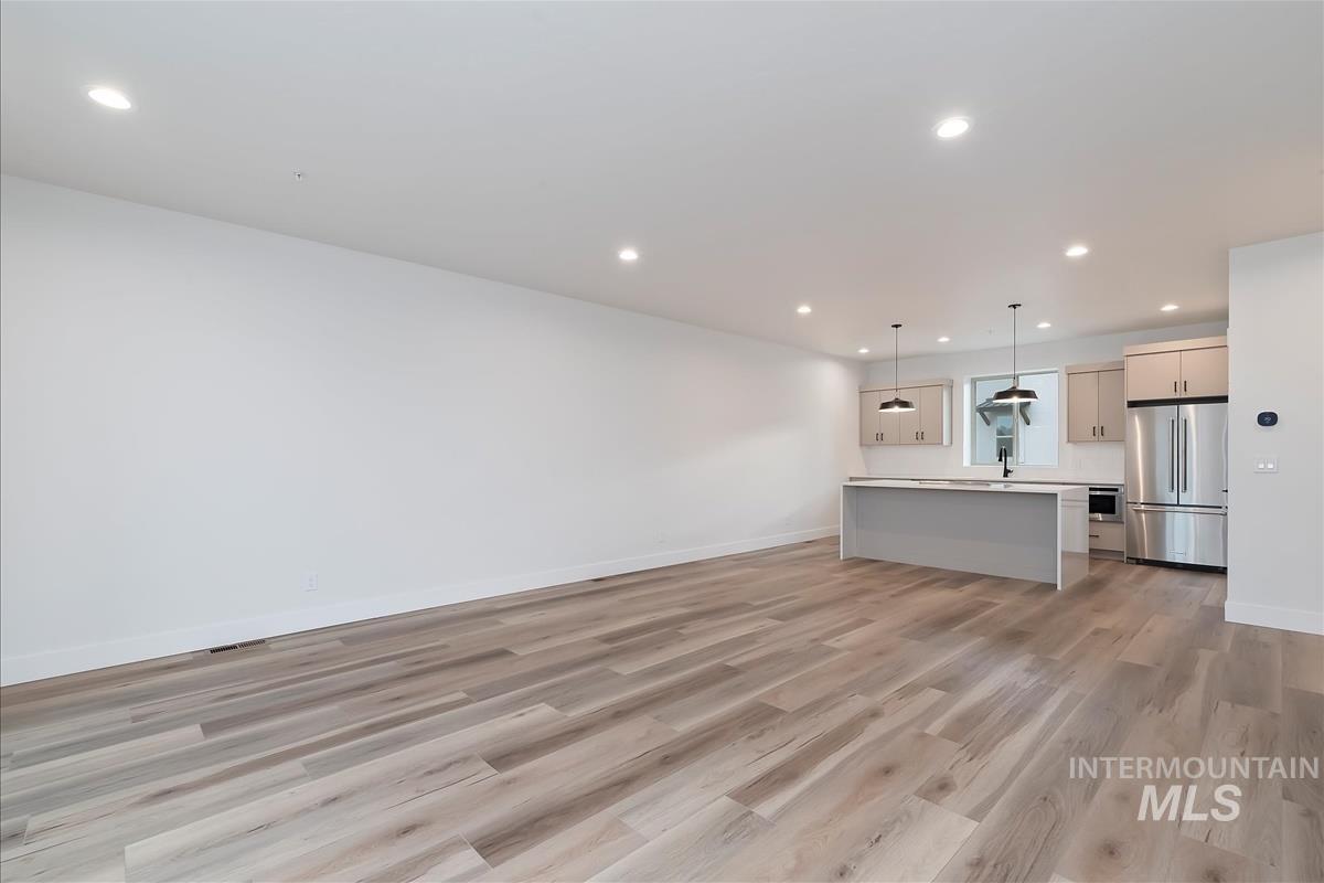Unfurnished living room with recessed lighting and light wood-style flooring