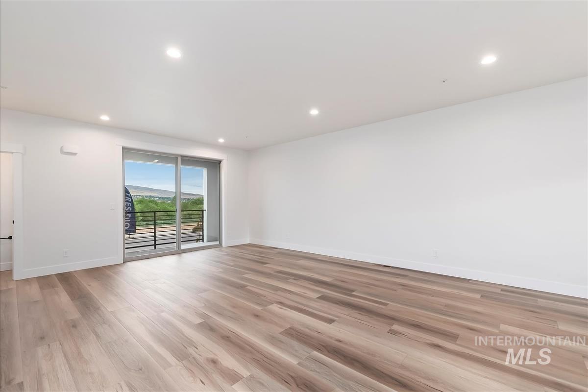 Spare room featuring light wood-style floors and recessed lighting