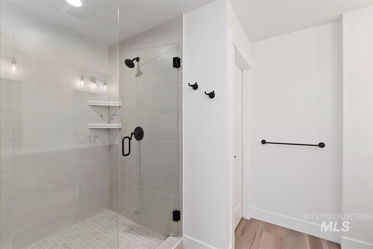 Bathroom featuring a stall shower and light wood finished floors