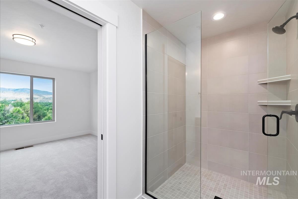 Full bathroom featuring a stall shower, a mountain view, and recessed lighting