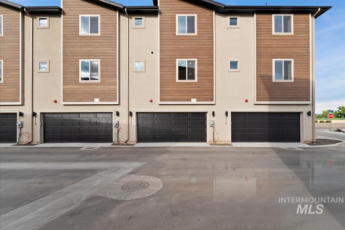 Rear view of property with an attached garage
