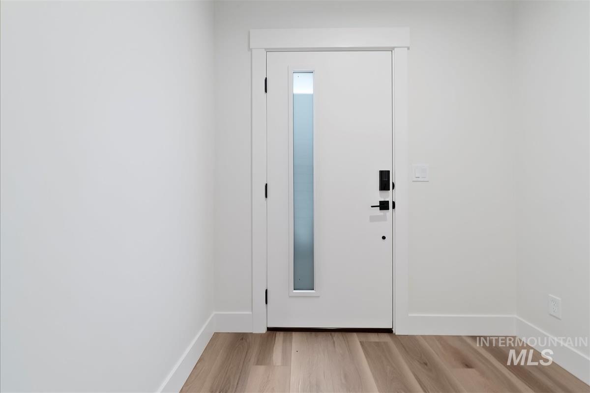 Entrance foyer featuring light wood finished floors and baseboards