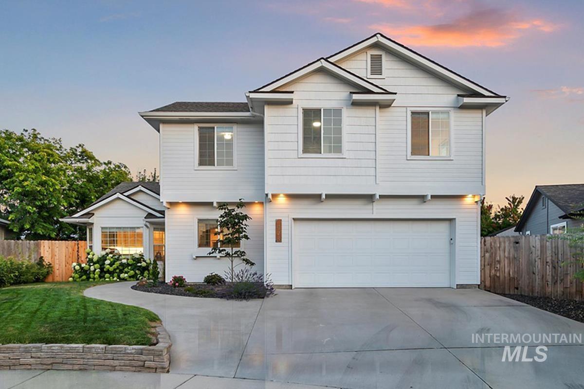 View of front facade featuring concrete driveway and an attached garage