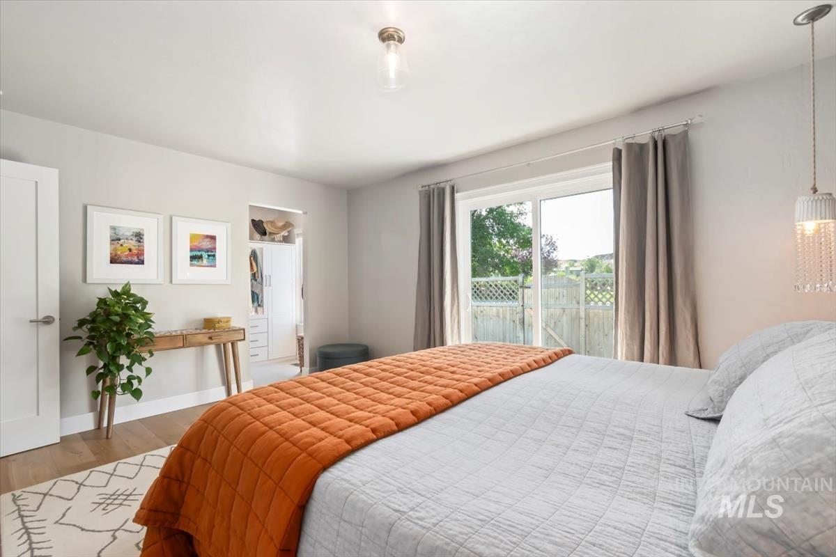 Bedroom with wood finished floors and baseboards