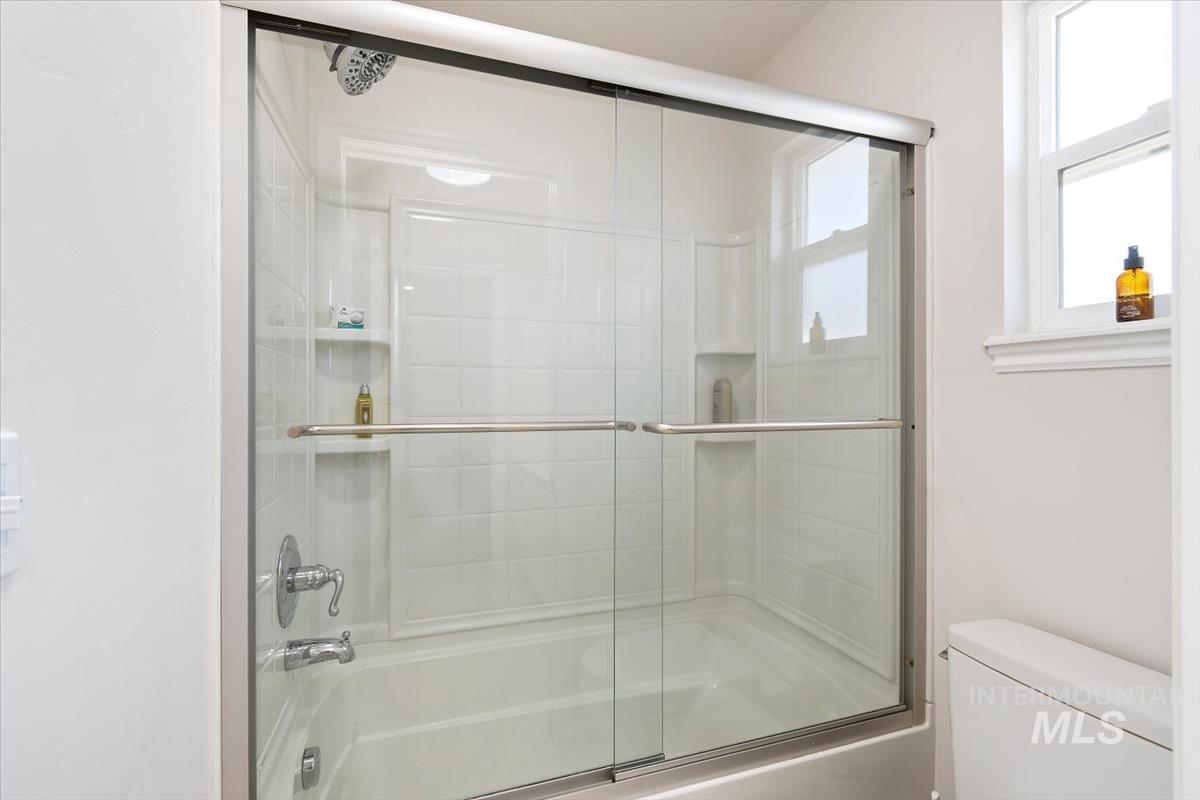 Bathroom with enclosed tub / shower combo