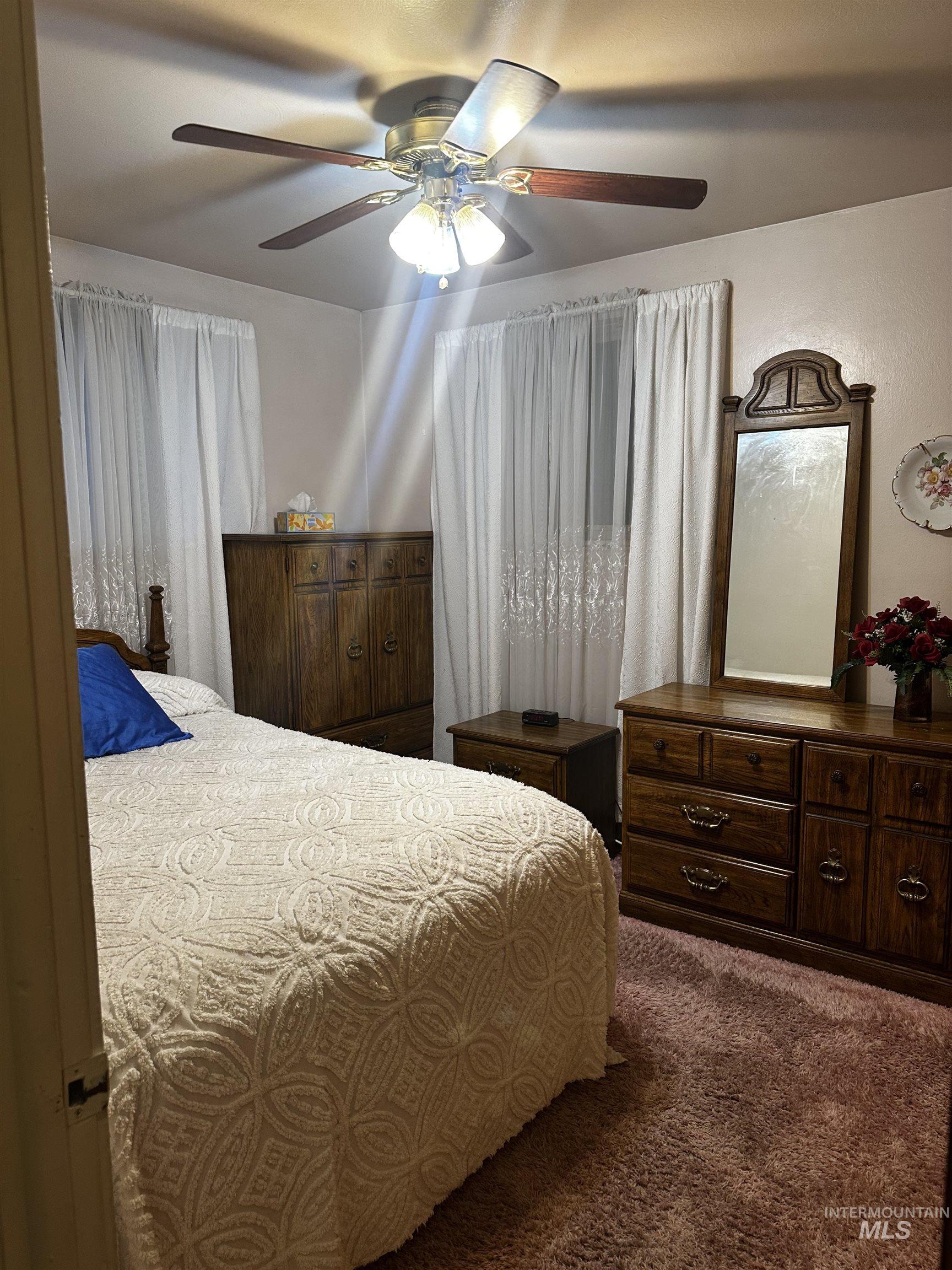 Bedroom with carpet flooring and ceiling fan
