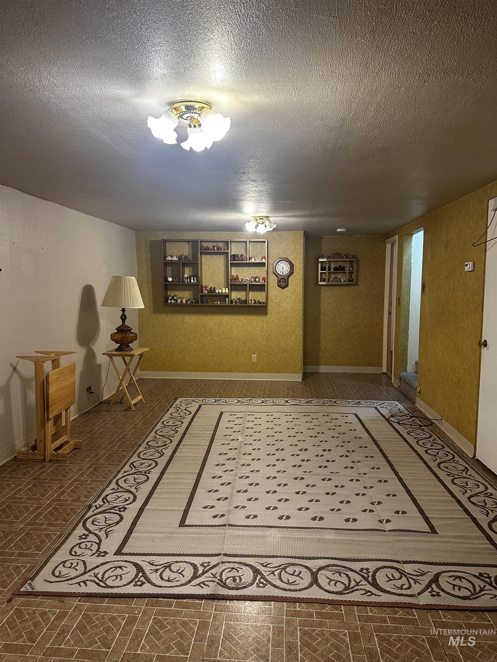Below grade area featuring a textured ceiling