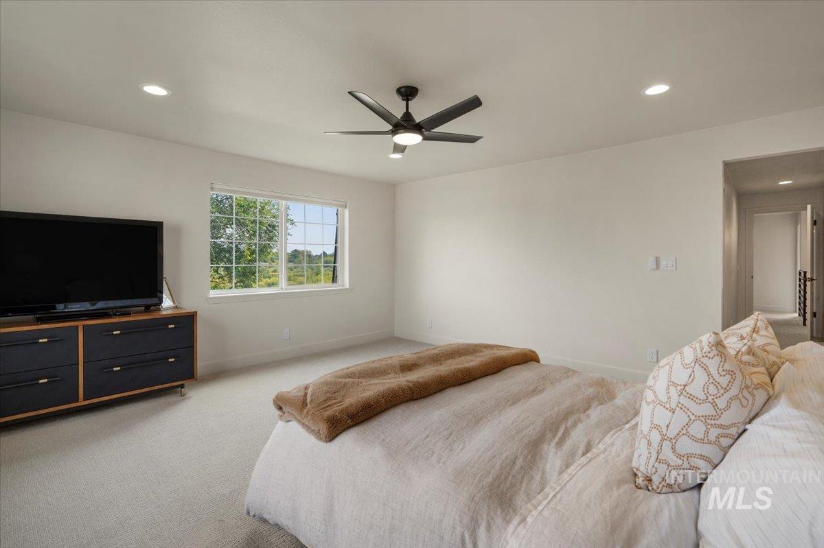 Bedroom with recessed lighting, light carpet, and ceiling fan