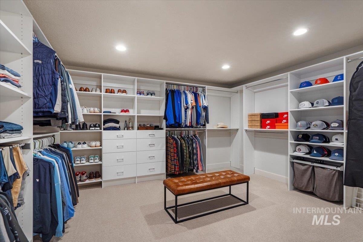 Walk in closet featuring light colored carpet