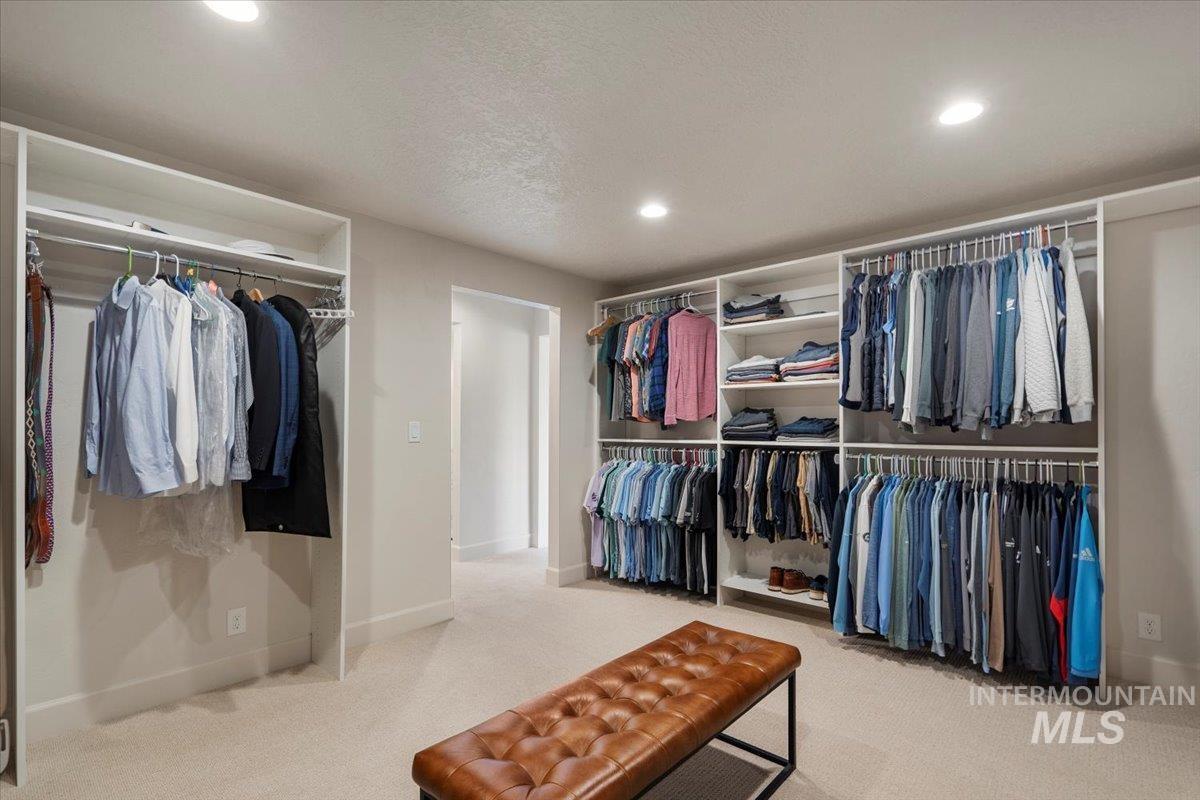 Walk in closet with light carpet