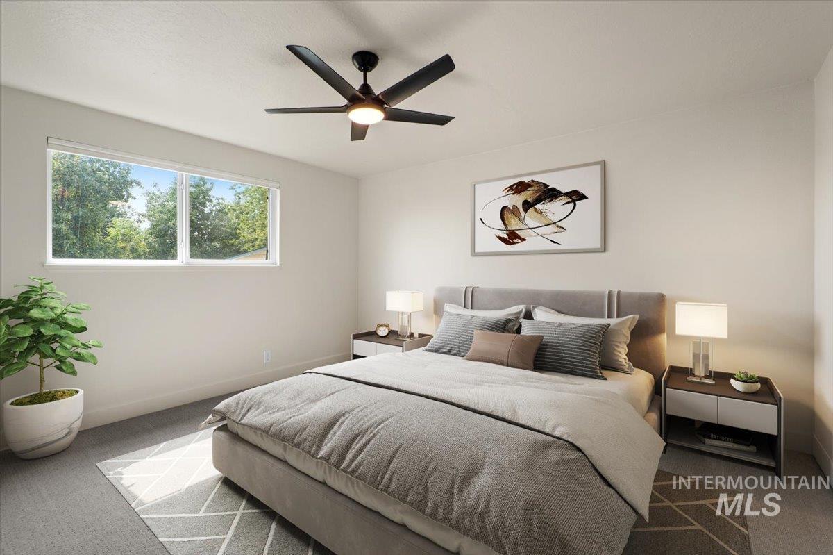 Carpeted bedroom with a ceiling fan and baseboards