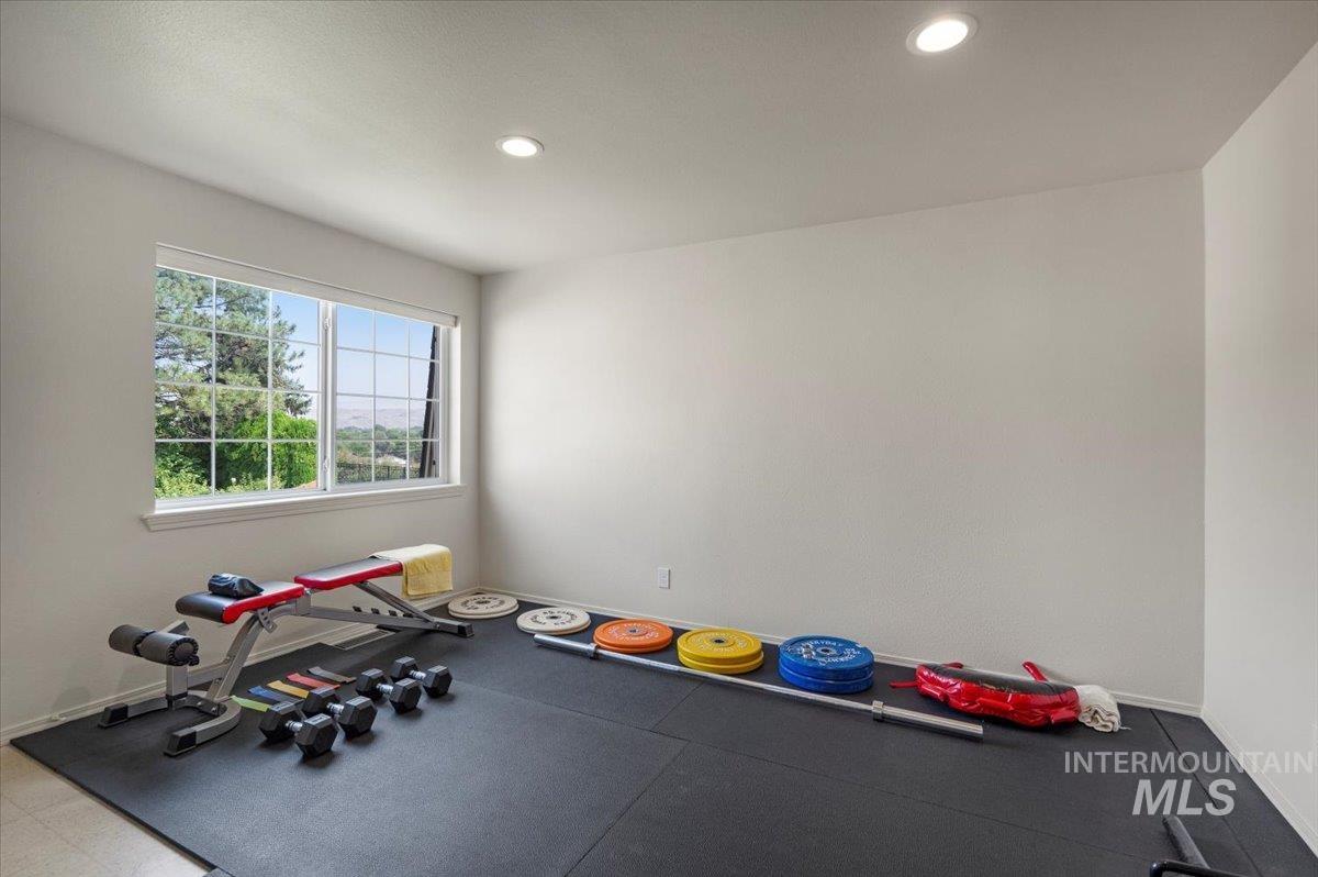 Exercise area featuring baseboards and recessed lighting