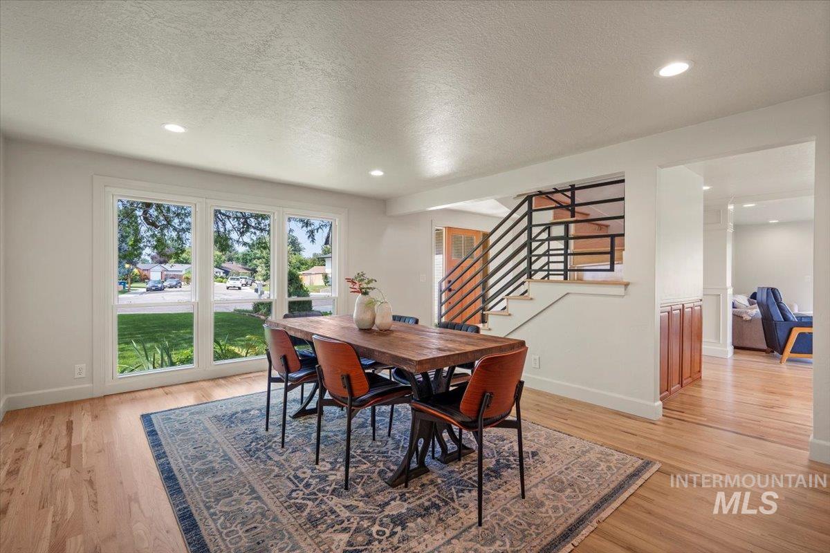 Dining room featuring stairway, a textured ceiling, recessed lighting, and light wood-type flooring