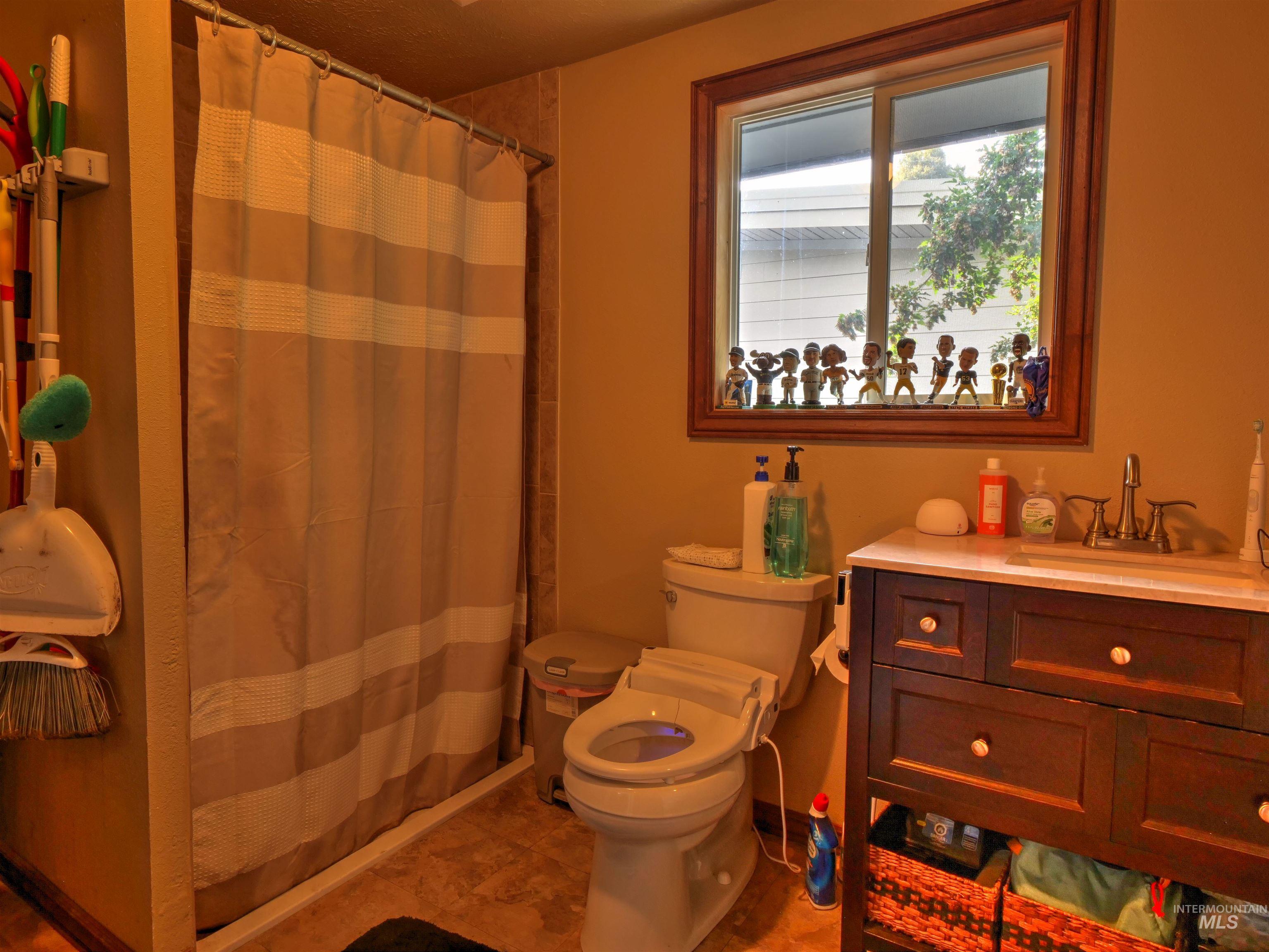 Full bath with vanity and a shower stall