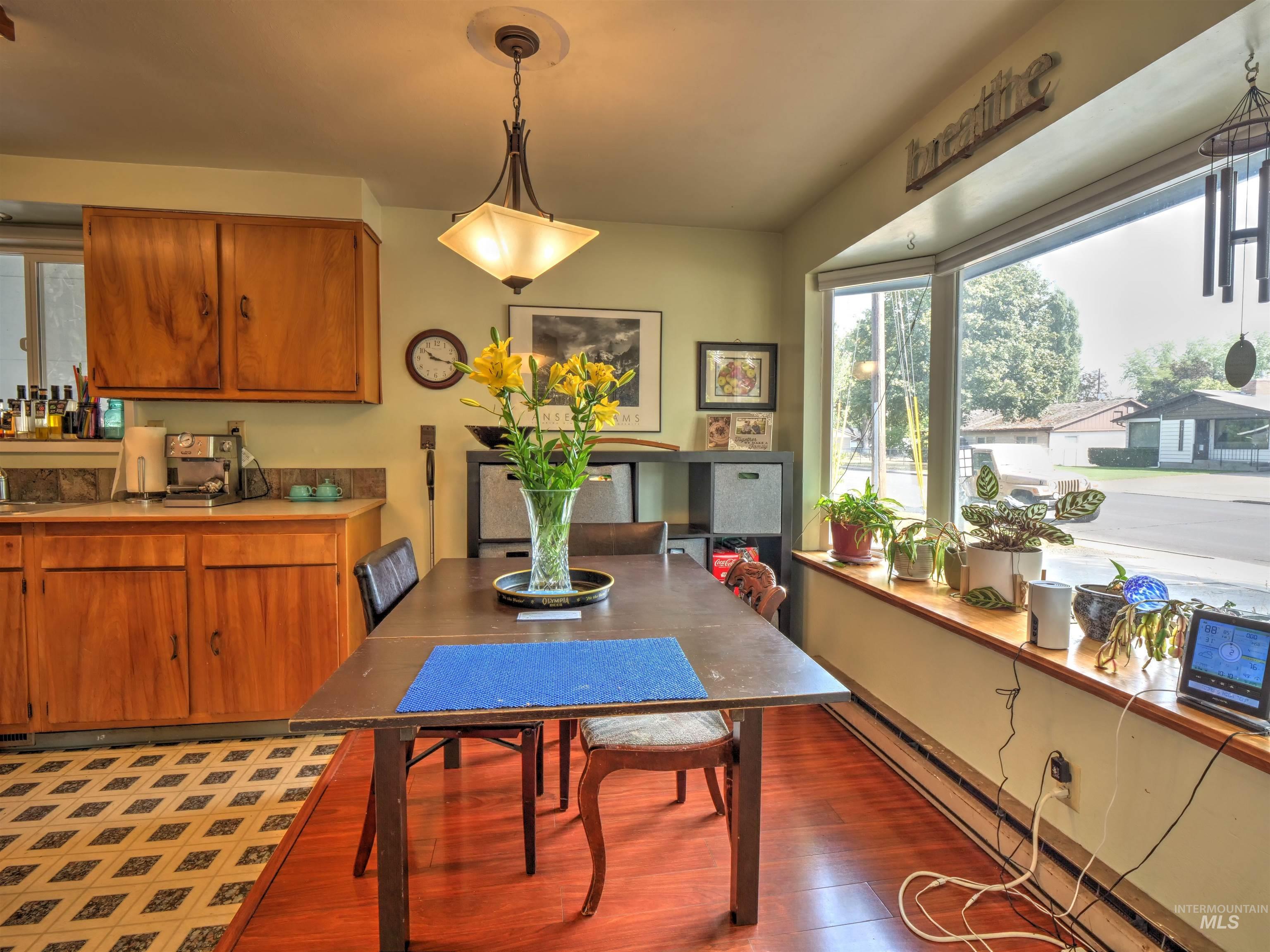 Dining area with light wood finished floors and baseboard heating