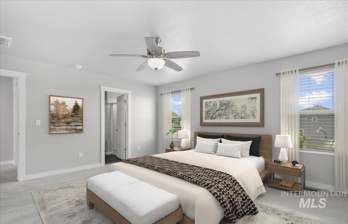 Bedroom featuring carpet floors, connected bathroom, and ceiling fan