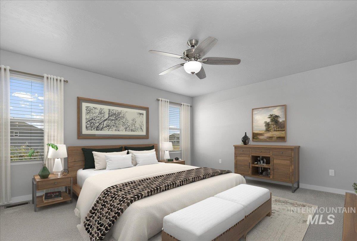 Carpeted bedroom featuring multiple windows, a ceiling fan, and a textured ceiling