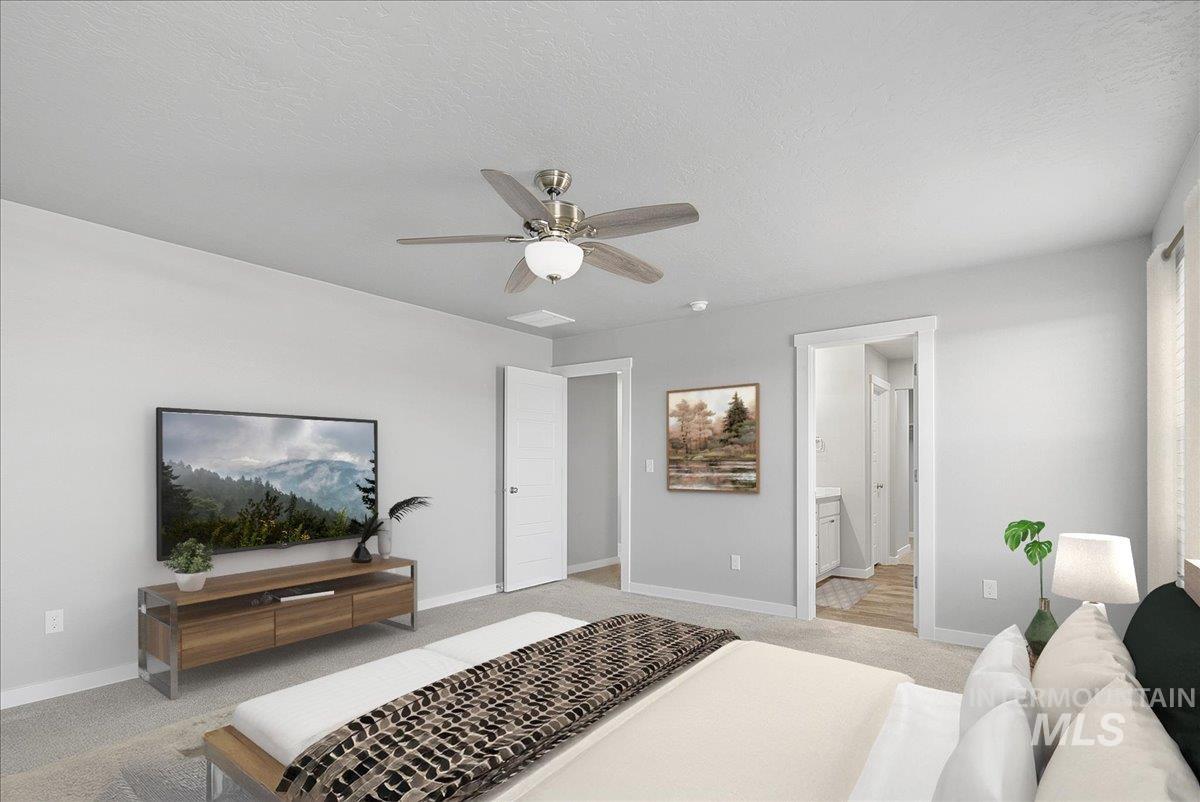 Bedroom with carpet floors, a textured ceiling, ceiling fan, and connected bathroom
