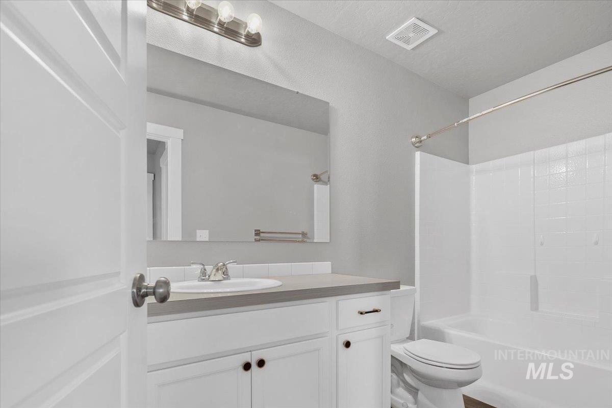 Full bath featuring vanity and shower / bathtub combination