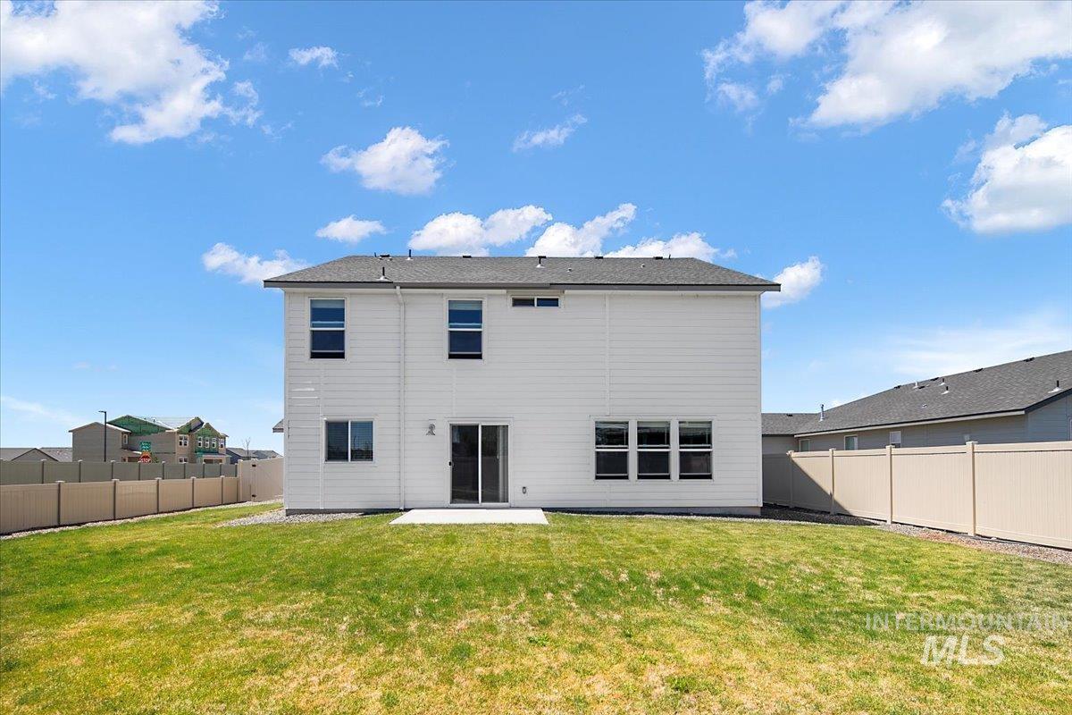 Back of property featuring a patio and a fenced backyard