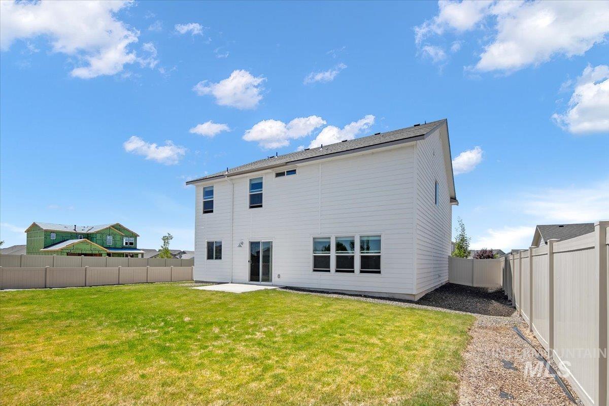 Rear view of house with a patio area and a fenced backyard