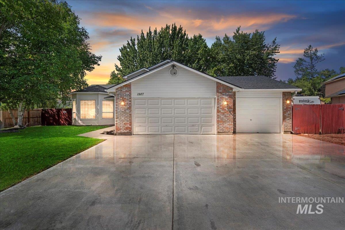 Ranch-style home with brick siding, concrete driveway, and an attached garage